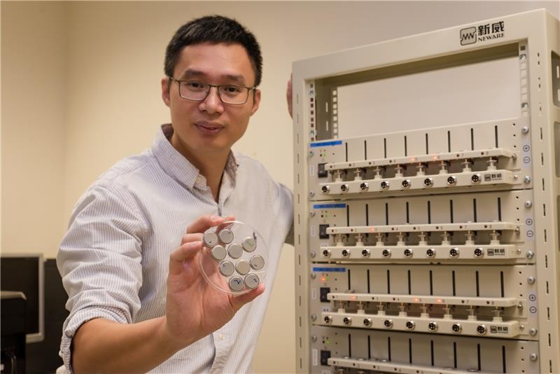 Associate professor Chen holding ultra-fast rechargeable batteries